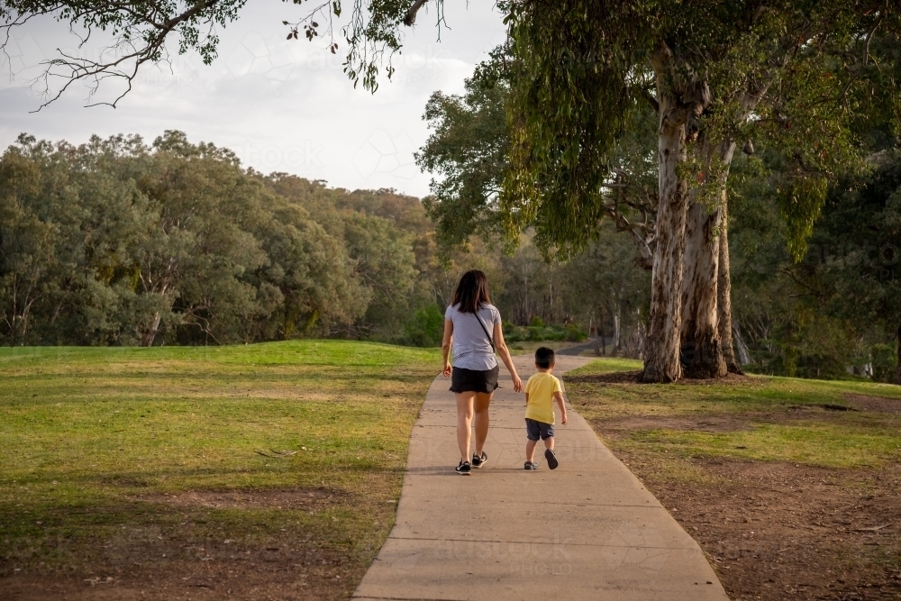 Mother and child walking together down a pathway in regional NSW - Australian Stock Image