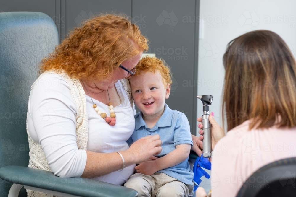 mother and child with doctor in doctor's surgery - Australian Stock Image