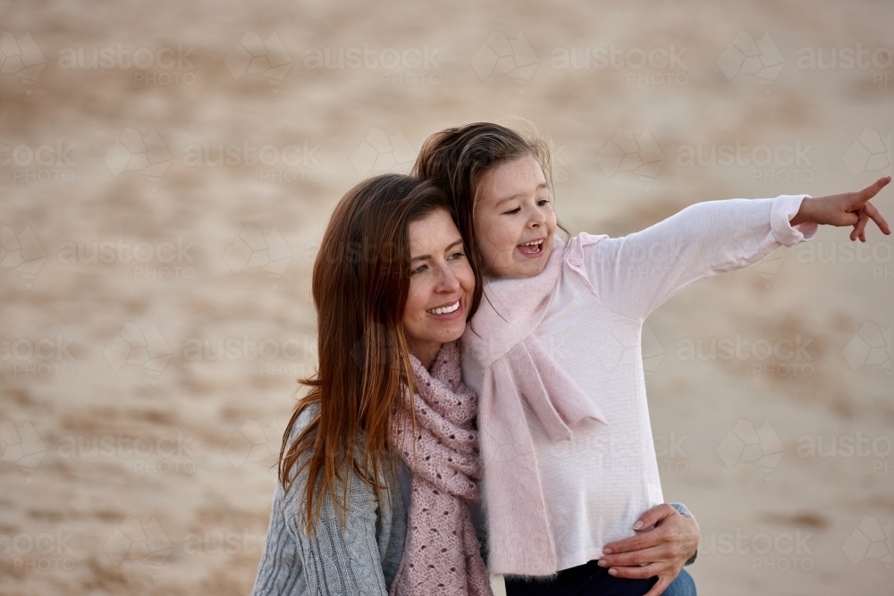 Mother and daughter at beach on sunset - Australian Stock Image
