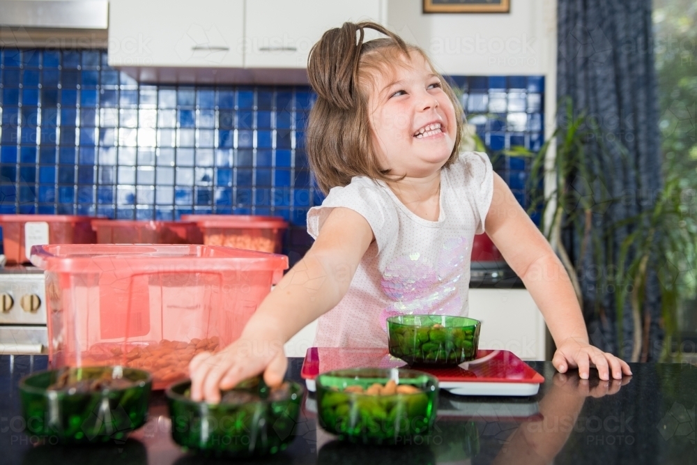 Mother and daughter cooking at home - Australian Stock Image