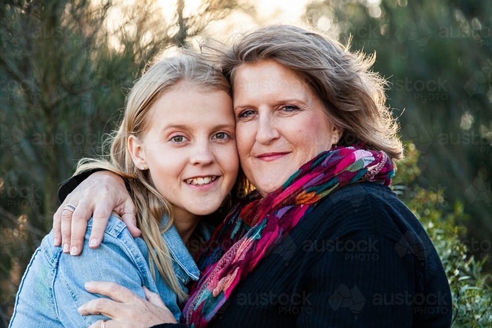 Mother and daughter hug portrait in winter - Australian Stock Image