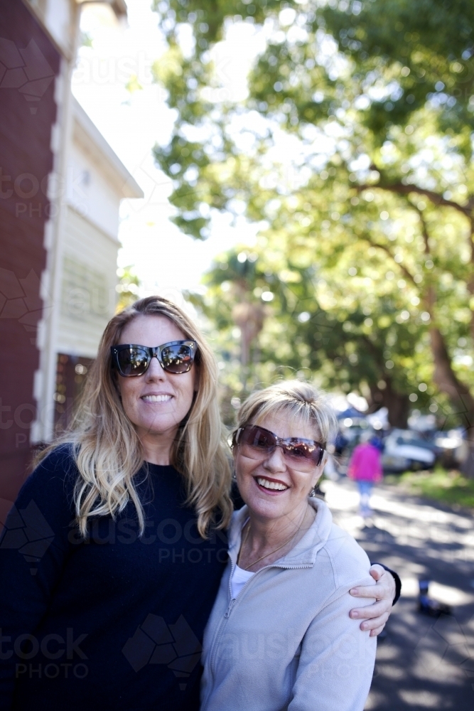 Mother and daughter hugging in outdoor setting - Australian Stock Image