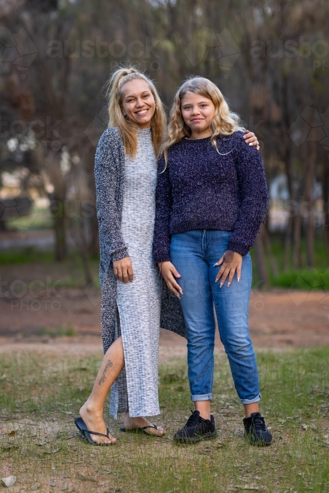mother and daughter standing together outside - Australian Stock Image