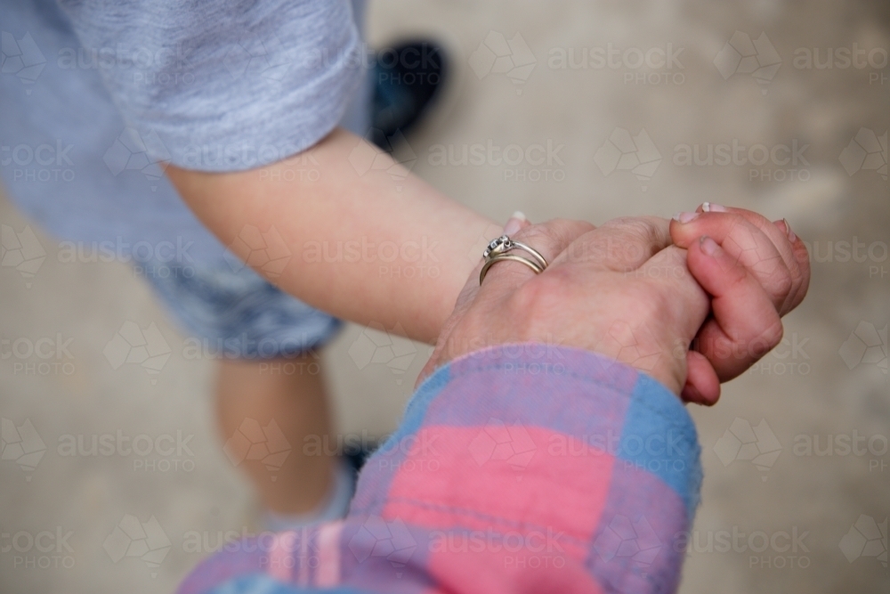 Mother and son holding hands - Australian Stock Image