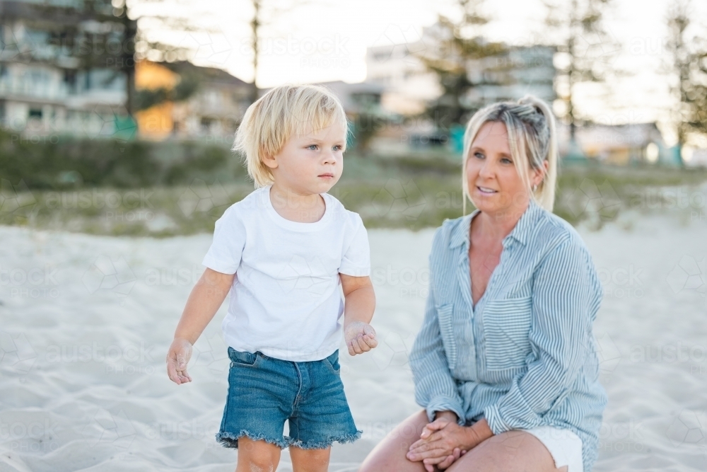 Mother and son playing on Gold Coast beach - Australian Stock Image