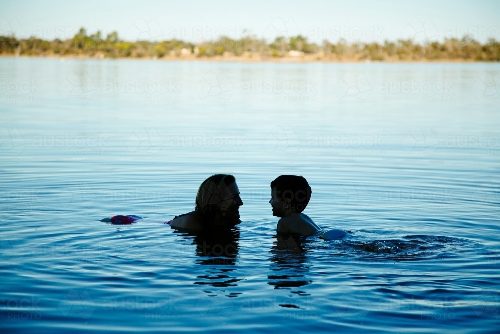 Mother and son swimming in a lake - Australian Stock Image