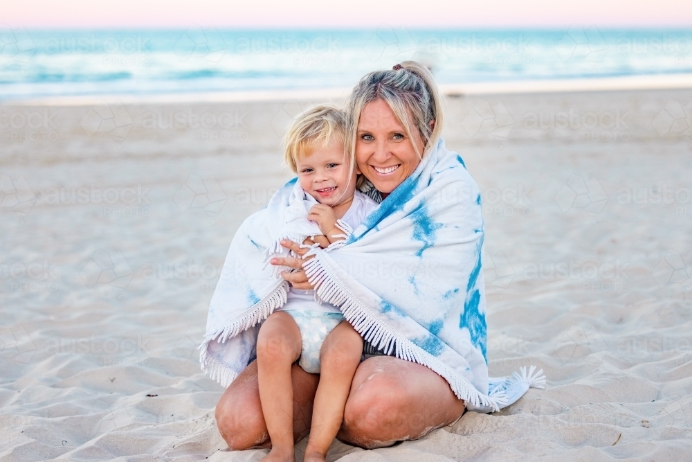 Mother and son wrapped in beach towel - Australian Stock Image