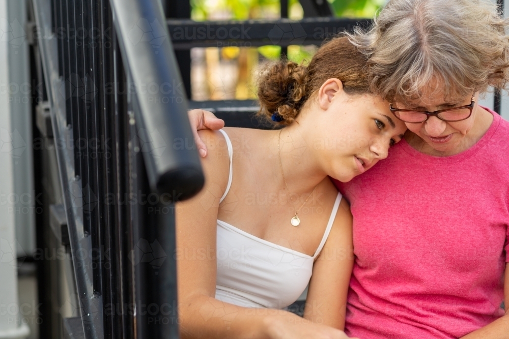 mother and teen daughter in close tender moment - Australian Stock Image