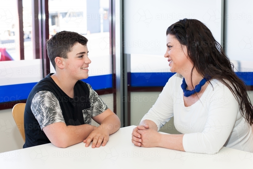 Mother and teenage son having a happy conversation - Australian Stock Image