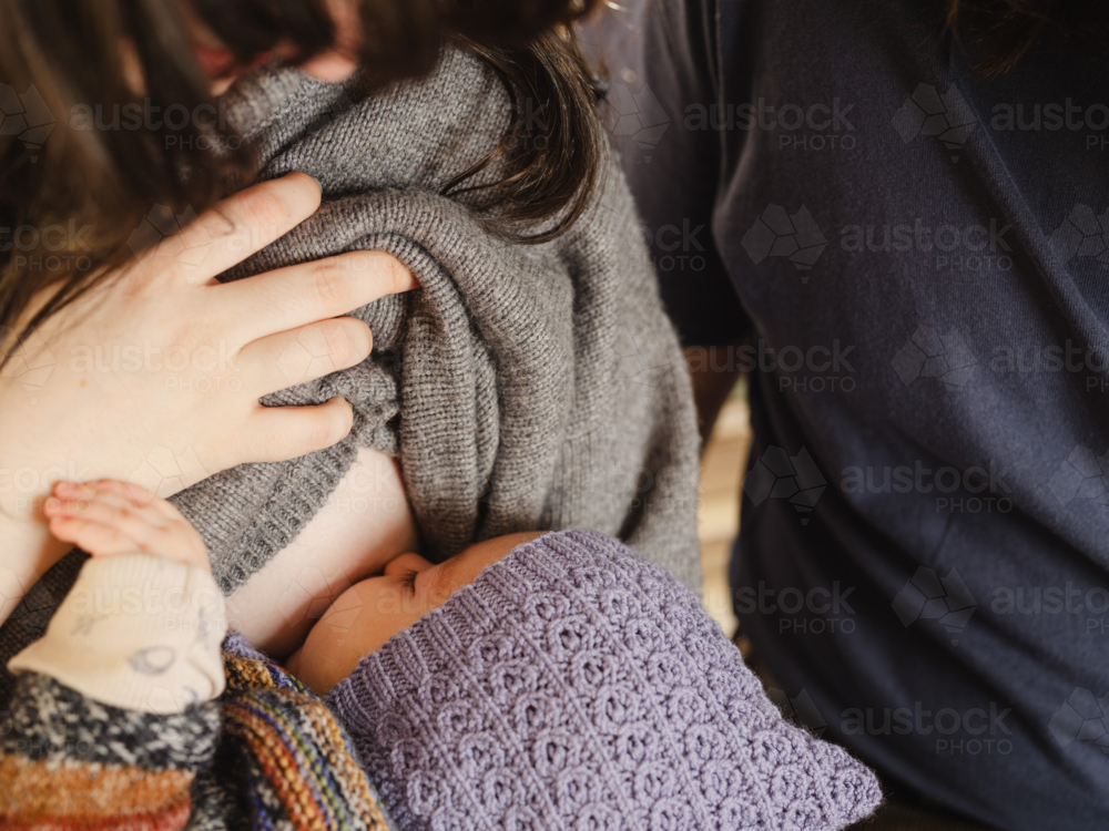Mother breastfeeding baby wearing beanie - Australian Stock Image