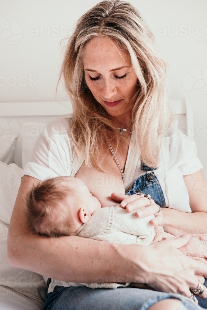 Mother bresst feeding new baby - Australian Stock Image