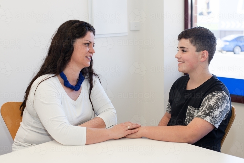 Mother having a happy conversation with her teenage son - Australian Stock Image