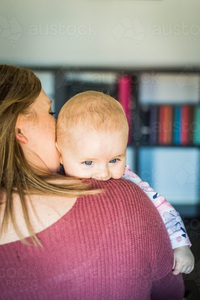 Mother holding baby over the shoulder - Australian Stock Image