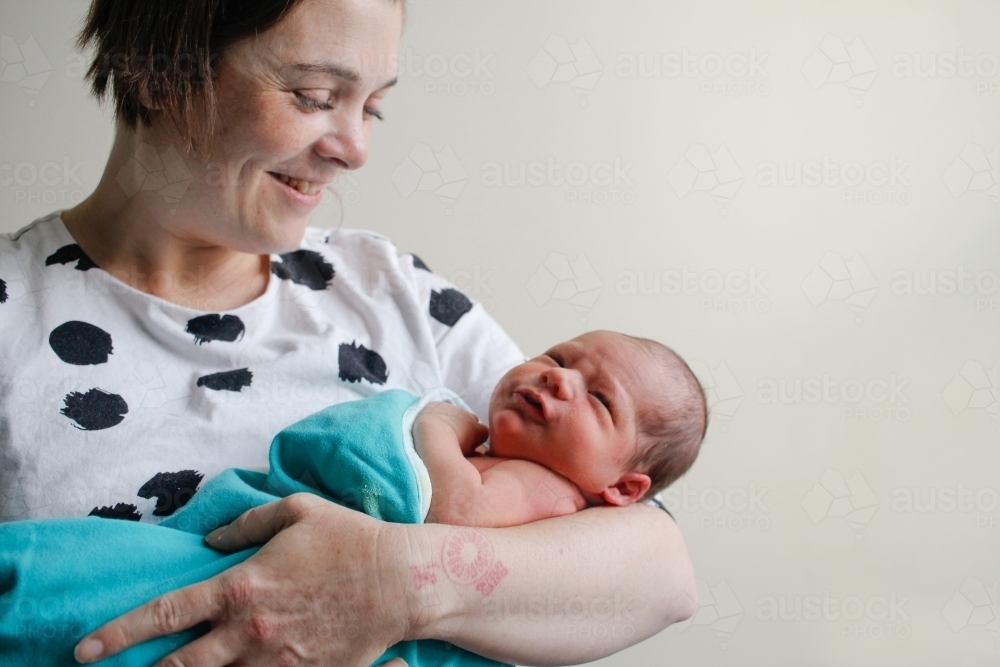 Mother holding her newborn child - Australian Stock Image