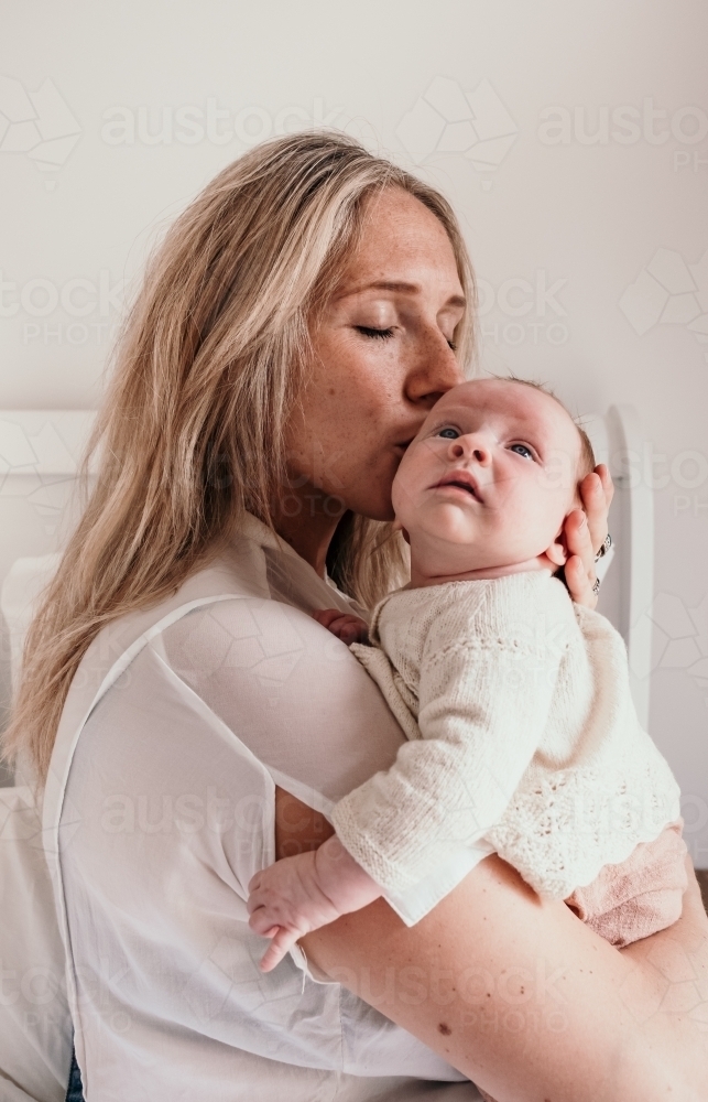 Mother kisses her baby tenderly. - Australian Stock Image