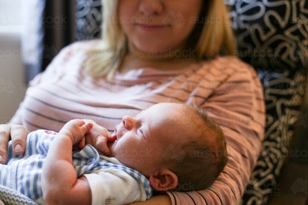 Mother nursing new born baby - Australian Stock Image