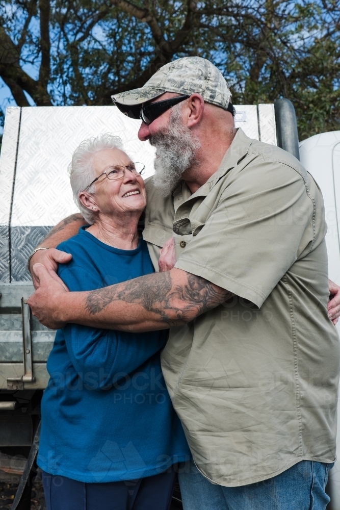 Mother welcomes her tradie son home. - Australian Stock Image