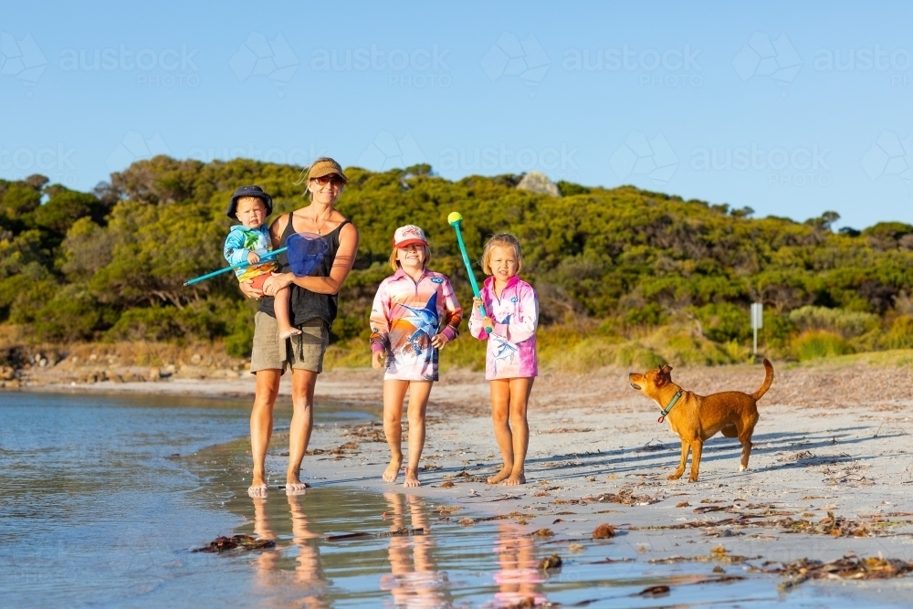 Mother with three children and pet dog at the beach - Australian Stock Image