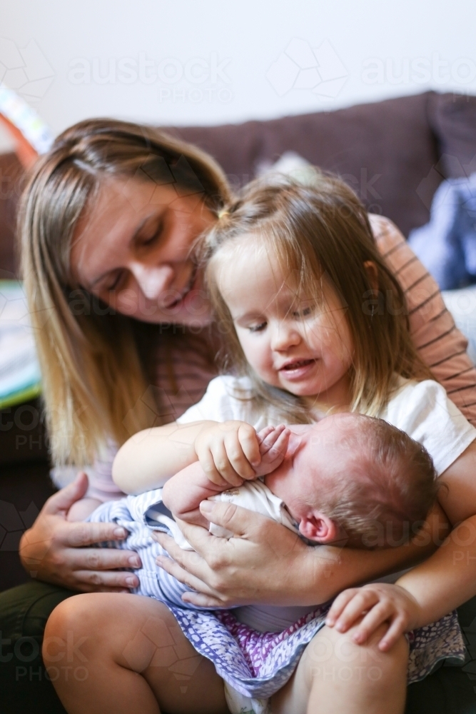 Mother with two children on her lap - Australian Stock Image