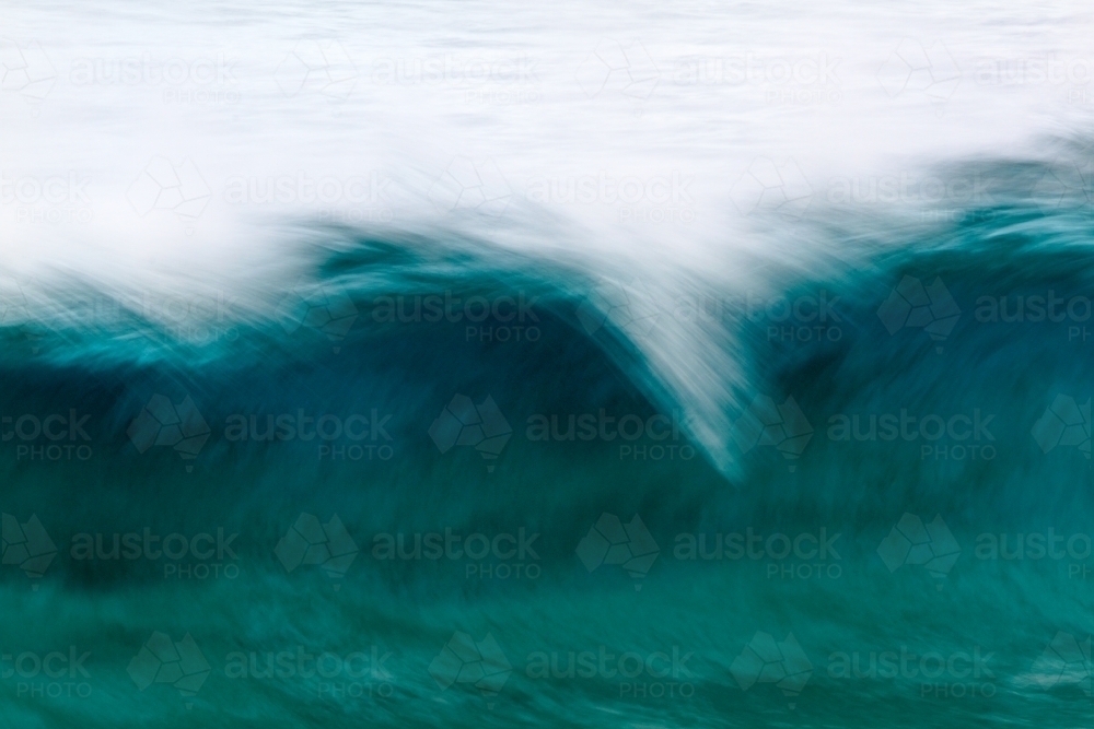 Motion blur abstract of a curling breaking wave at Norries Head, Cabarita Beach - Australian Stock Image
