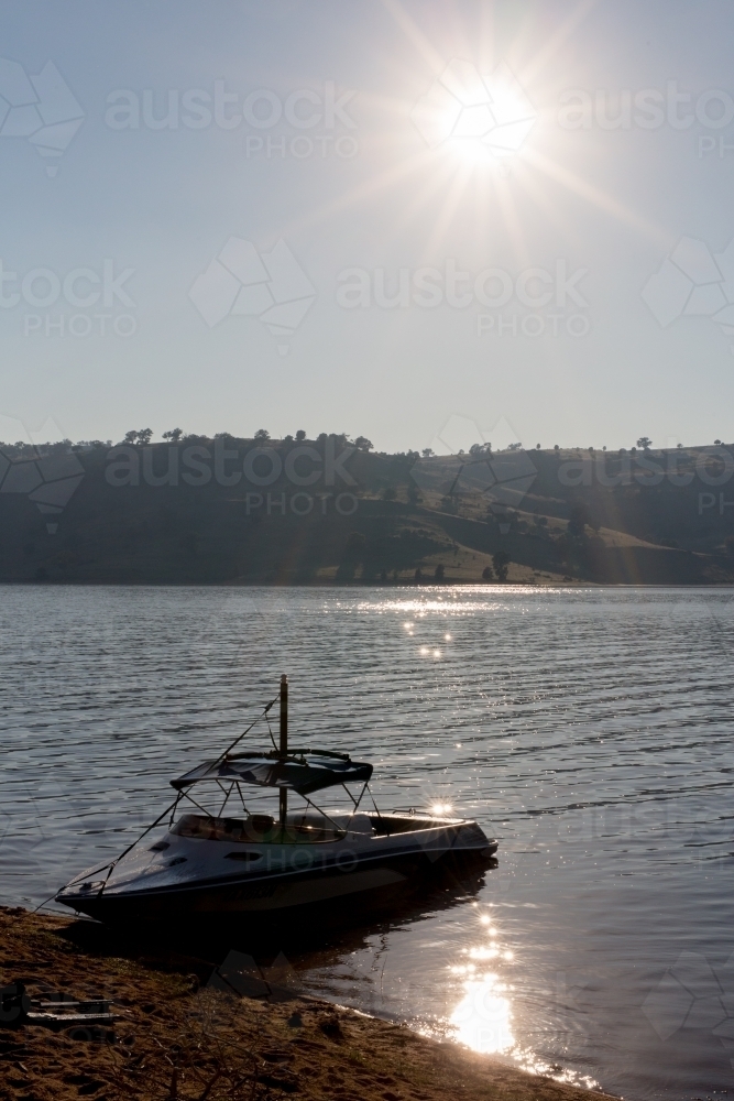 Motor boat at wyangala dam bank with sunshine - Australian Stock Image