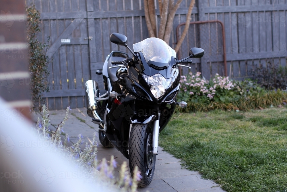 Motorbike in garden - Australian Stock Image