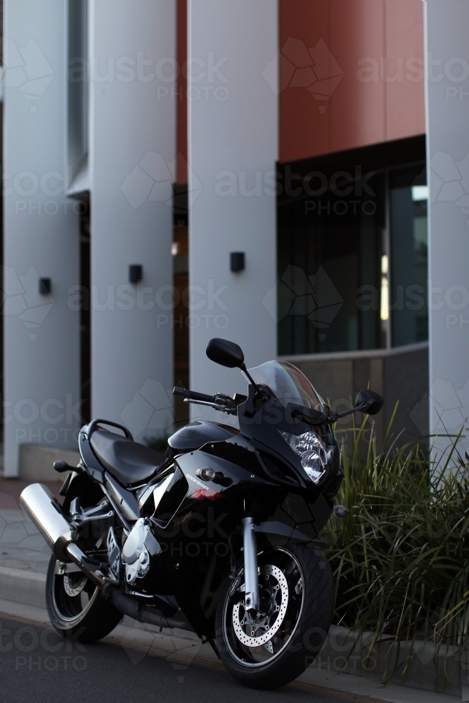 Motorbike parked on a suburban street - Australian Stock Image