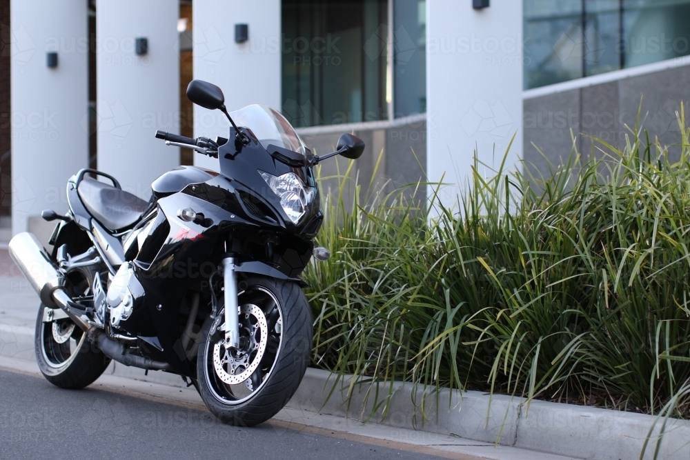 Motorbike parked on a suburban street - Australian Stock Image