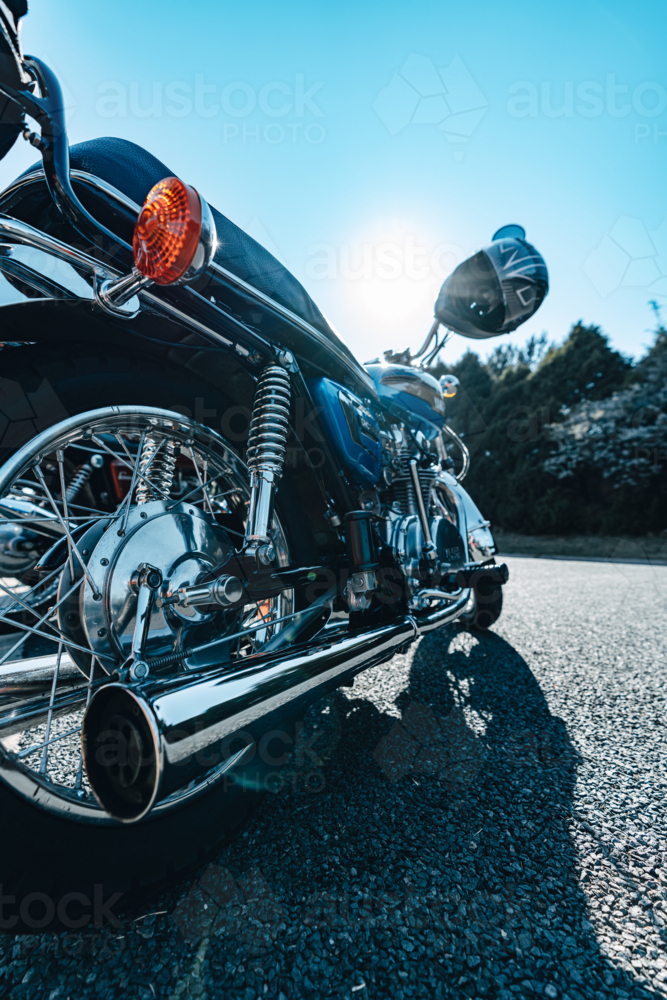 Motorbike with sunflare and helmet - Australian Stock Image