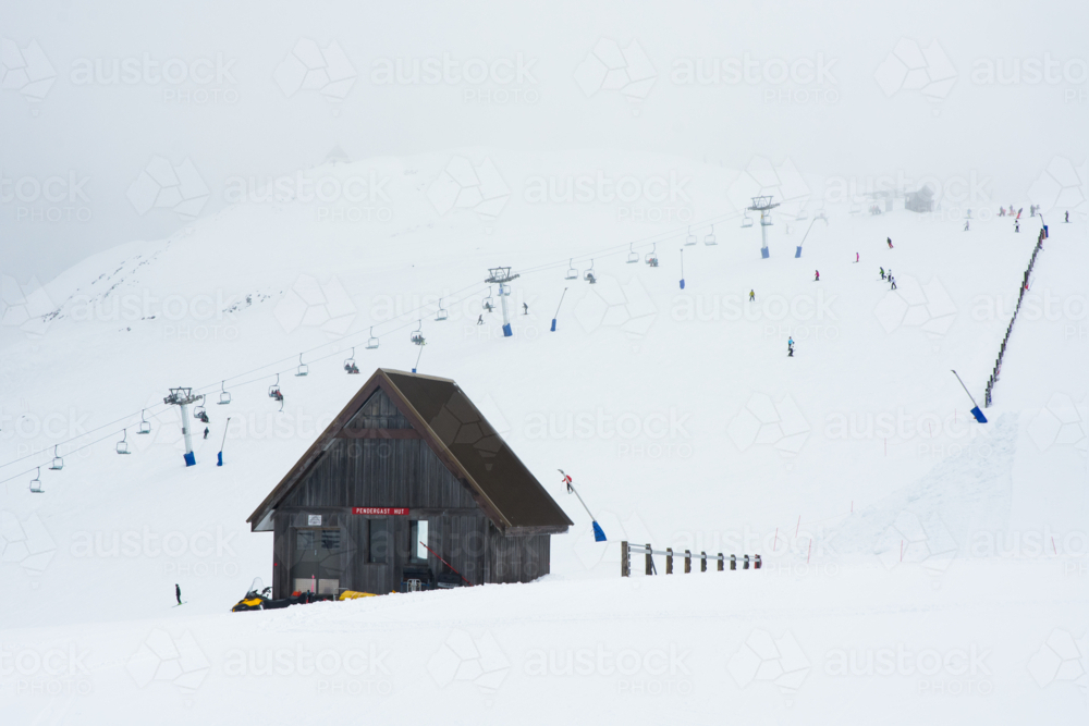 Mountain hut with ski lift in the background - Australian Stock Image