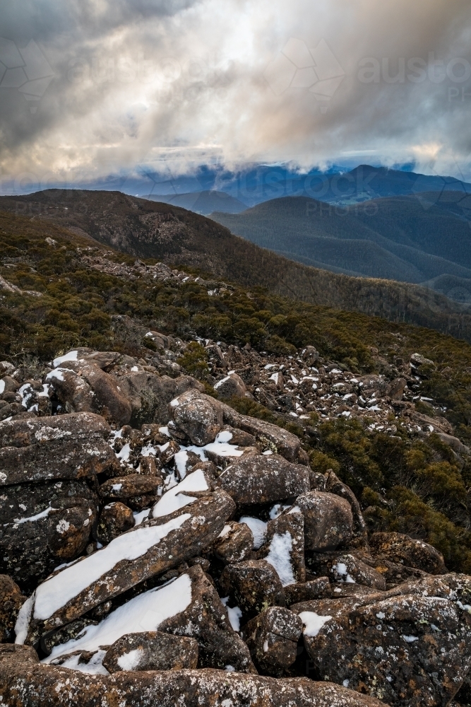 mountain landscape with rocks and snow - Australian Stock Image