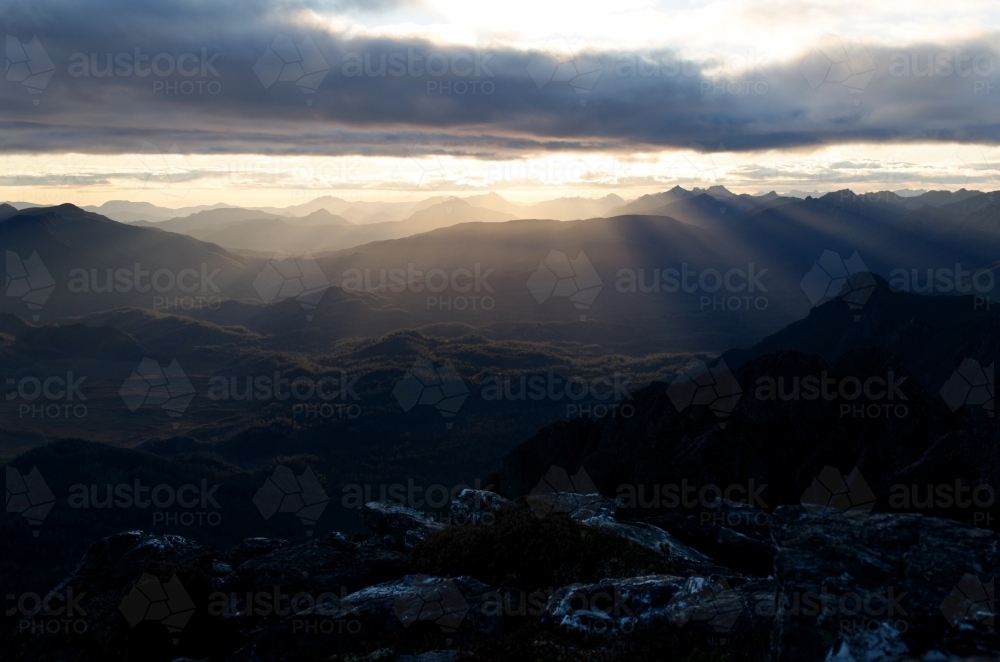 Mountain range at dusk with rays of light - Australian Stock Image