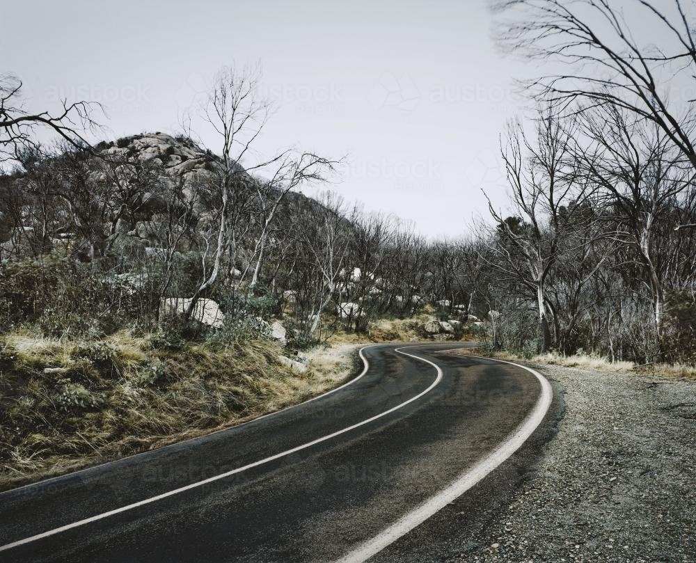 Mountain Road through bleak winter landscape - Australian Stock Image