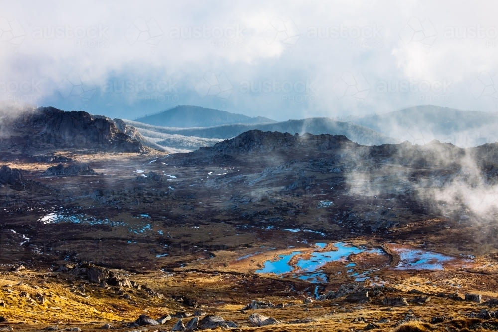 Mountain terrain, light and clouds from Mt Kosciuszko - Australian Stock Image