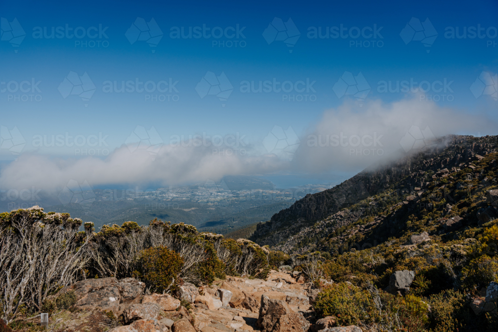 Mountainous terrain covered in a soft veil of clouds - Australian Stock Image