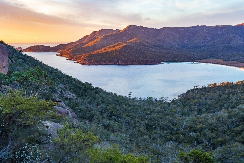 Mountains and valleys around Wine Glass Bay in early morning sunshine - Australian Stock Image