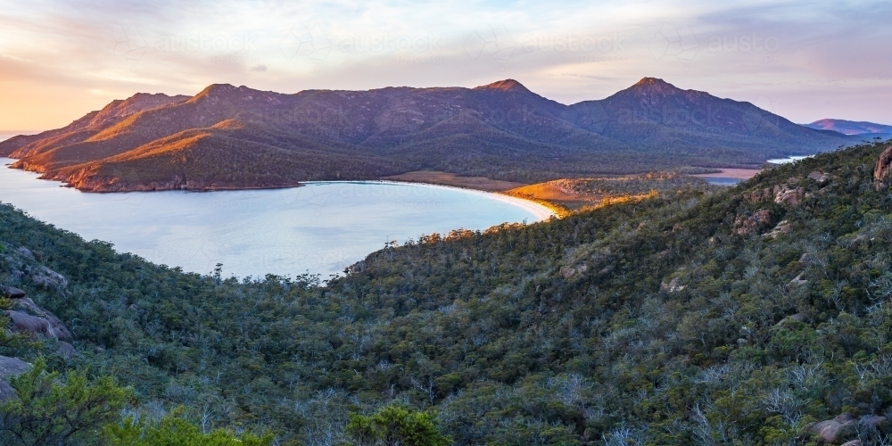 Mountains and valleys around Wine Glass Bay in early morning sunshine - Australian Stock Image