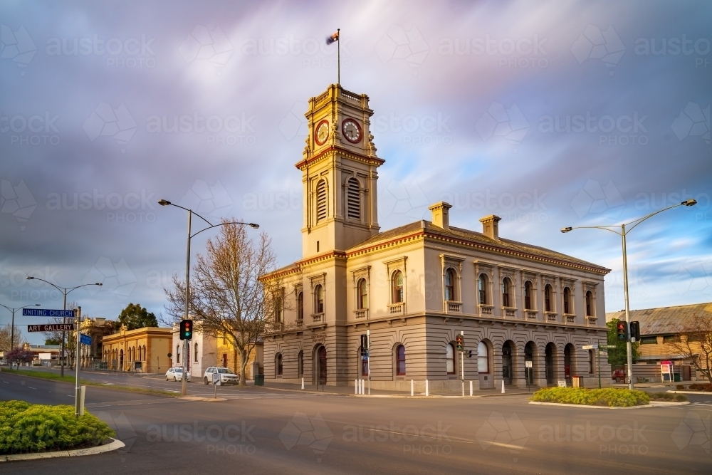 Moving clouds over a rural town intersection with an historic post office - Australian Stock Image