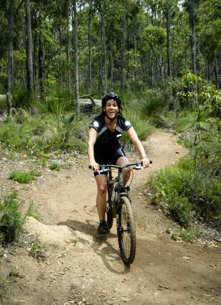 Woman Recreationally Mountain Biking bush trails - Australian Stock Image