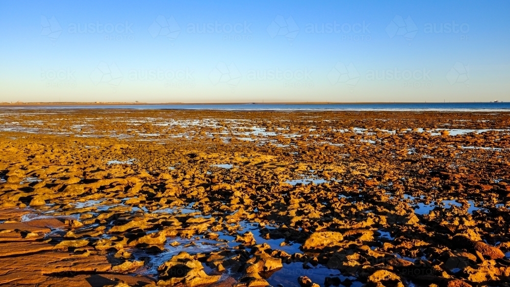 Mud flats and rock formation at Roebuck Bay - Australian Stock Image