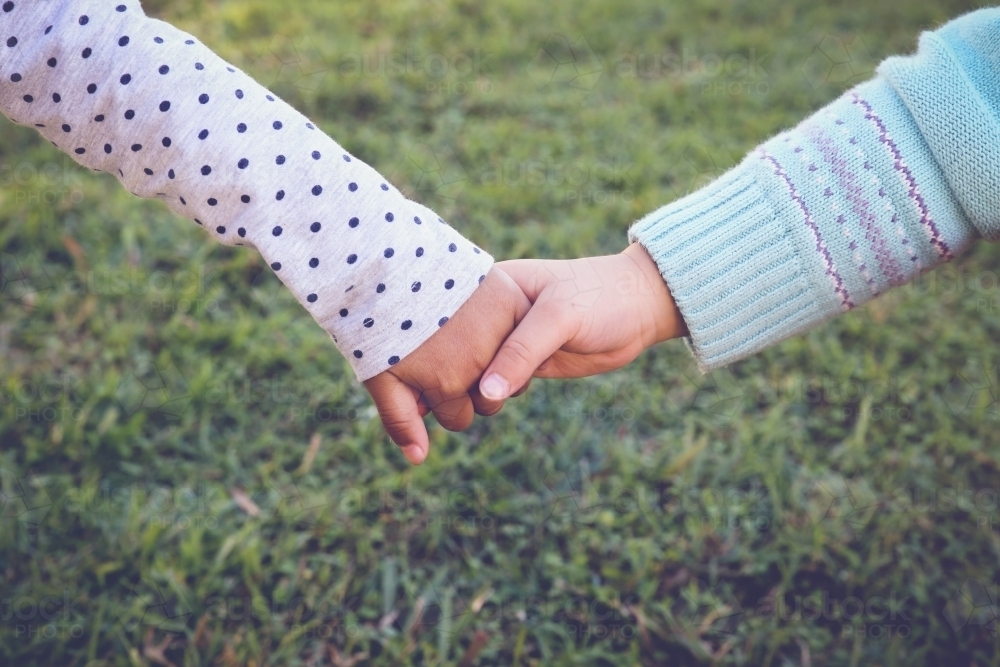 Multi-ethnic chidren holding hands for peace, diversity, friendship concept - Australian Stock Image