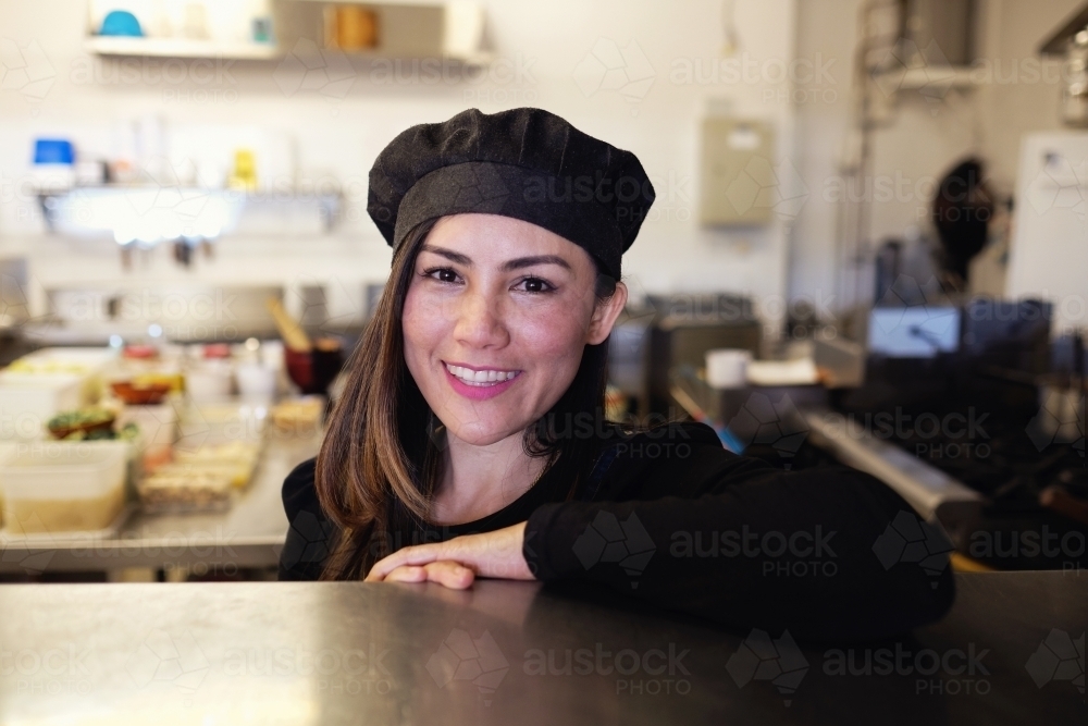 Multicultural Asian chef in Thai small business restaurant - Australian Stock Image