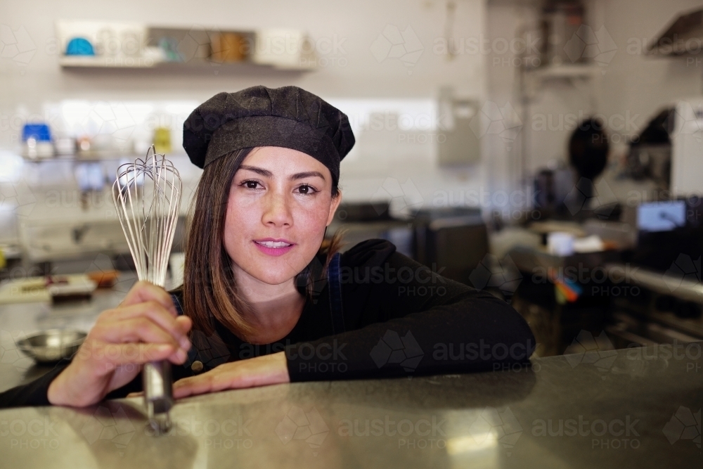 Multicultural Asian chef in Thai small business restaurant - Australian Stock Image