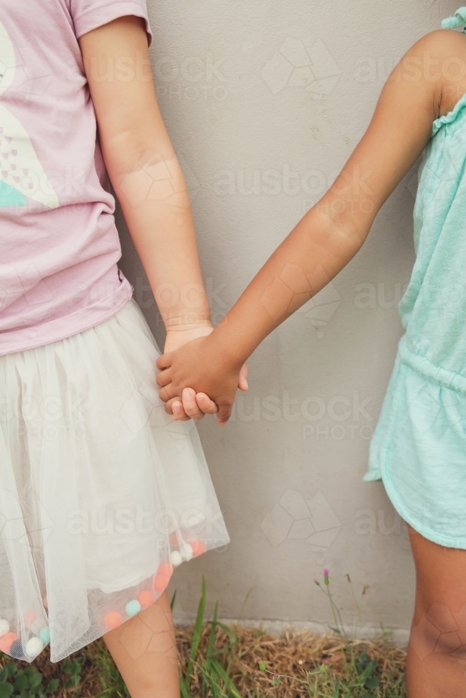 Multicultural children holding hands - Australian Stock Image
