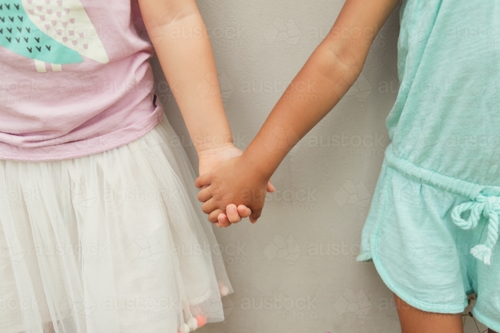 Multicultural children holding hands - Australian Stock Image