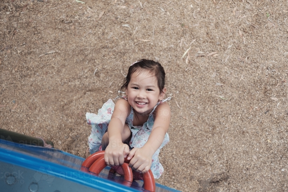 multicultural kid having fun at playground - Australian Stock Image