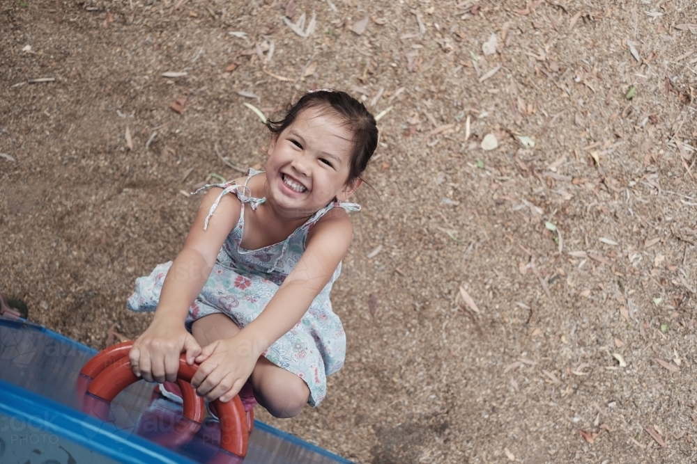 multicultural kid having fun at playground - Australian Stock Image