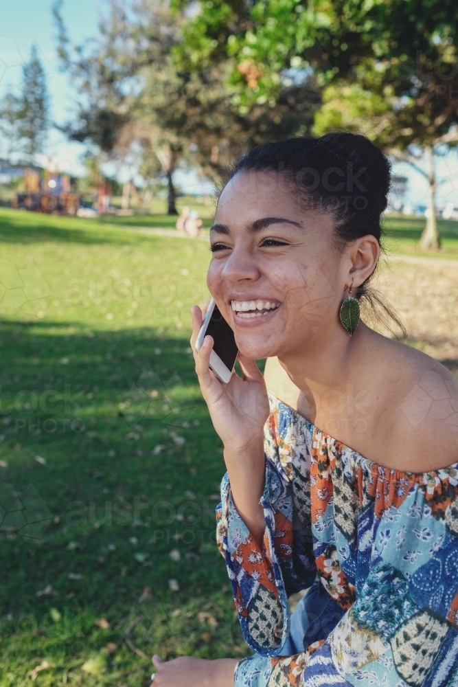Multicultural teen girl on the phone - Australian Stock Image