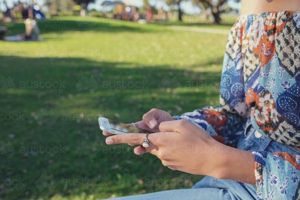 Multicultural teen girl using mobile phone - Australian Stock Image