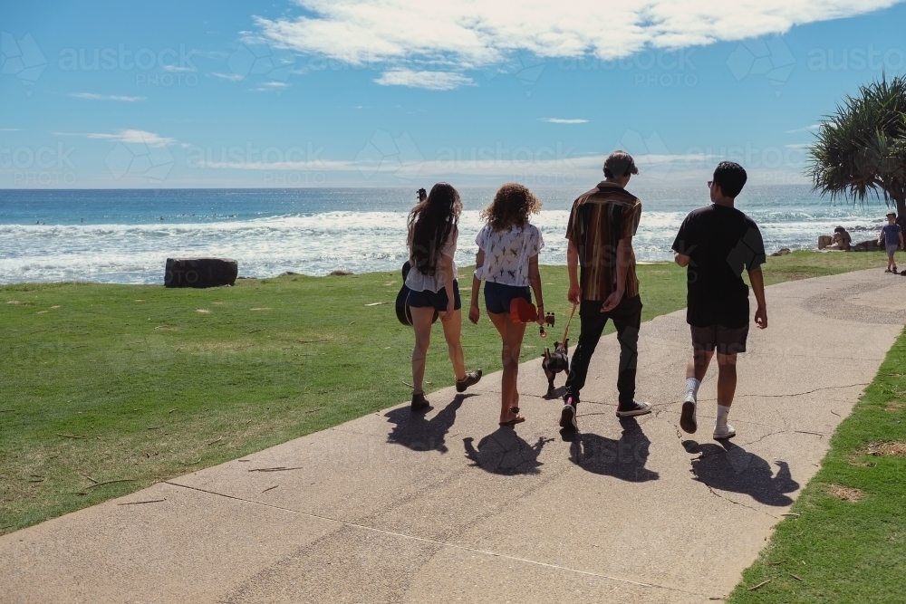Multicultural teenagers walking near the beach - Australian Stock Image